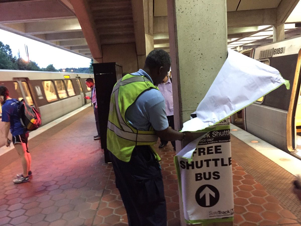 A Metro staff worker removes temporary signage that directed commuters to the wrong trains at the West Falls Church Metrorail station on Thursday, Sept. 15, 2016, when the ninth and longest phase of Metro’s system wide maintenance overhaul began. (WTOP/Neal Augenstein)