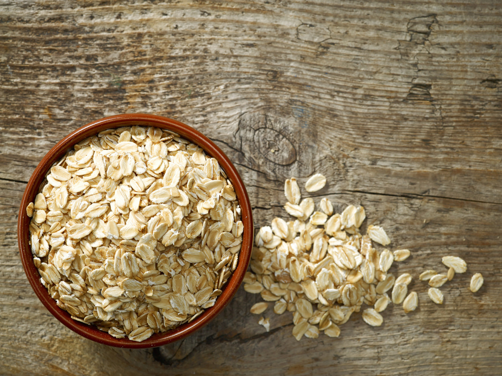 bowl of oat flakes on old wooden table