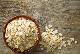 bowl of oat flakes on old wooden table