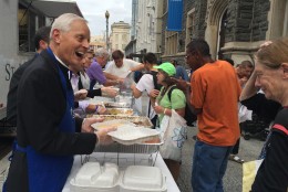 Cardinal Donald Wuerl, Archbishop of Washington, greeted and helped serve dinner to the needy Wednesday outside Catholic Charities in Northwest. The weekly meal is part of Catholic Charities' Maria's Meals Program. (WTOP/Michelle Basch)