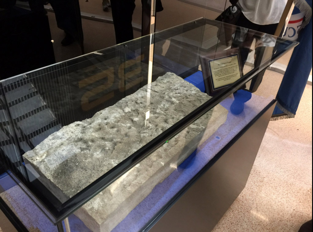A limestone tablet from a a wall at the Pentagon damaged during the Sept. 11, 2001 terror attacks now lies on display at Dulles International Airport. Staff with the Transportation Security Administration held a ceremony to unveil the stone tablet on Thursday, Sept. 1, 2016. (WTOP/Kristi King)