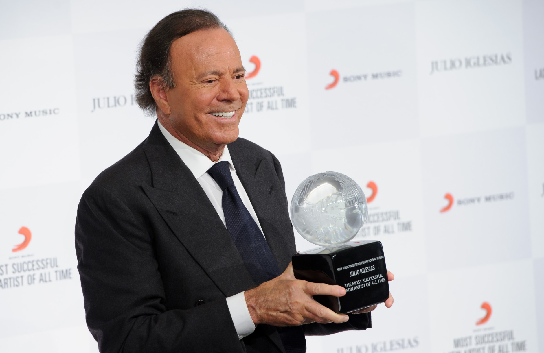Spanish singer Julio Iglesias poses for photographers poses at a press conference with his award after being named the 'Most Successful Latin Artist of All Time',  at a central London venue, Monday, May 12, 2014. (Photo by Jonathan Short/Invision/AP)