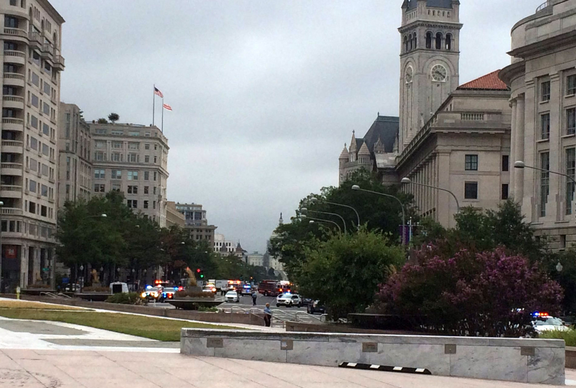 Numerous police cars fill Pennsylvania Avenue near the new Trump hotel as they investigated a suspicious package. The Warner Theatre and other nearby buildings were evacuated and entrances to the Metro Center Station were closed. Related road closures brought traffic to a near halt downtown as the morning commute was wrapping up on Tuesayd. Sept. 20, 2016. (WTOP/Nick Iannelli)
