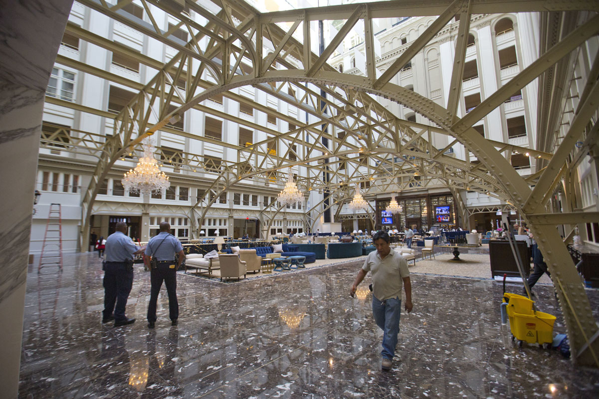 Main lobby of the Trump International Hotel in downtown Washington, Monday, Sept. 12, 2016. The luxury hotel Donald Trump has built in an iconic downtown Washington building is set to open. The Trump International Hotel will begin serving guests Monday. There won't be any fanfare around the opening, which is known as a "soft opening." Grand-opening ceremonies are being planned for October. The Trump Organization won a 60-year lease from the federal government to transform the Old Post Office building on Pennsylvania Avenue into a hotel. (AP Photo/Pablo Martinez Monsivais)