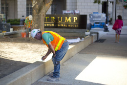Workers continue work outside the Trump International Hotel in downtown Washington, Monday, Sept. 12, 2016. The luxury hotel Donald Trump has built in an iconic downtown Washington building is set to open. The Trump International Hotel will begin serving guests Monday. There won't be any fanfare around the opening, which is known as a "soft opening." Grand-opening ceremonies are being planned for October. The Trump Organization won a 60-year lease from the federal government to transform the Old Post Office building on Pennsylvania Avenue into a hotel. (AP Photo/Pablo Martinez Monsivais)