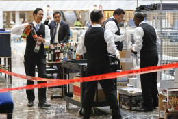 Workers begin to stock the bar with liquor at the Trump International Hotel in downtown Washington, Monday, Sept. 12, 2016 in Washington. The luxury hotel Donald Trump has built in an iconic downtown Washington building is set to open. The Trump International Hotel will begin serving guests Monday. There won't be any fanfare around the opening, which is known as a "soft opening." Grand-opening ceremonies are being planned for October. The Trump Organization won a 60-year lease from the federal government to transform the Old Post Office building on Pennsylvania Avenue into a hotel. (AP Photo/Pablo Martinez Monsivais)