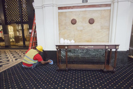 A worker cleans the marble in the lobby of the Trump International Hotel in downtown Washington, Monday, Sept. 12, 2016 in Washington. The luxury hotel Donald Trump has built in an iconic downtown Washington building is set to open. The Trump International Hotel will begin serving guests Monday. There won't be any fanfare around the opening, which is known as a "soft opening." Grand-opening ceremonies are being planned for October. The Trump Organization won a 60-year lease from the federal government to transform the Old Post Office building on Pennsylvania Avenue into a hotel. (AP Photo/Pablo Martinez Monsivais)