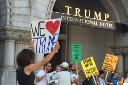 A counter-demonstrator outside the Trump International Hotel on Pennsylvania Avenue in D.C. The hotel held a "soft opening" on Sept. 12. The Trump Organization won a 60-year lease from the federal government to transform the Old Post Office building into a hotel. (WTOP photo/Rich Johnson)