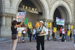 A counter-demonstrater outside the Trump International Hotel on Pennsylvania Avenue in D.C. The hotel held a "soft opening" on Sept. 12. The Trump Organization won a 60-year lease from the federal government to transform the Old Post Office building into a hotel. (WTOP photo/Rich Johnson)