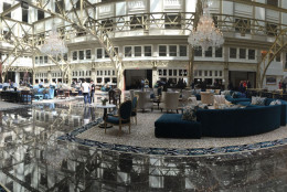 A panorma of the grand lobby of the Trump International Hotel on Pennsylvania Avenue in D.C. The hotel held a "soft opening" on Sept. 12. The Trump Organization won a 60-year lease from the federal government to transform the Old Post Office building into a hotel. (WTOP photo/Rich Johnson)