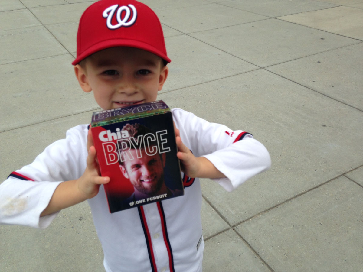 Tucker Prohaska shows off his prize from the Center Field plaza bag grab. The 3-year-old is wearing part of his Jayson Werth Halloween costume his dad says he won't take off. He didn't bring the shaggy beard. (WTOP/Megan Cloherty)