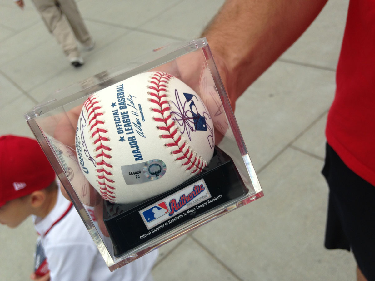 Dad Jeremy Prohaska walked away with the team autographed baseball. (WTOP/Megan Cloherty)