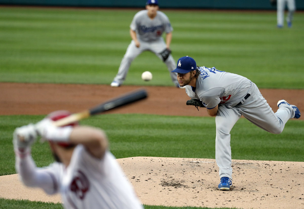 Los Angeles Dodgers starting pitcher Clayton Kershaw, right, throws to Washington Nationals' Bryce Harper during the first inning of Game 1 of baseball's National League Division Series, at Nationals Park, Friday, Oct. 7, 2016, in Washington. (AP Photo/Alex Brandon)