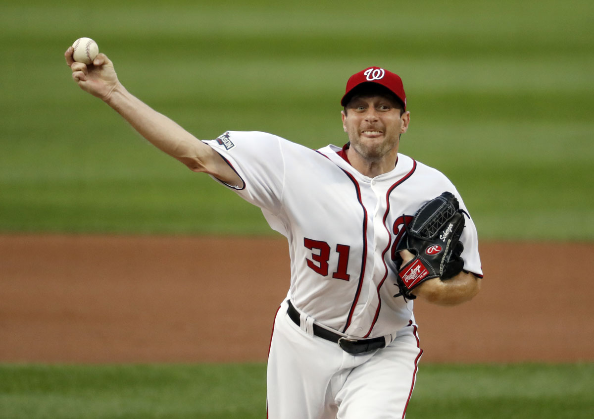 Washington Nationals starting pitcher Max Scherzer throws during the first inning of Game 1 of baseball's National League Division Series against the Los Angeles Dodgers at Nationals Park, Friday, Oct. 7, 2016, in Washington. (AP Photo/Alex Brandon)