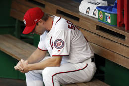 Washington Nationals starting pitcher Max Scherzer pauses in the dugout before Game 1 of baseball's National League Division Series against the Los Angeles Dodgers at Nationals Park, Friday, Oct. 7, 2016, in Washington. (AP Photo/Alex Brandon)