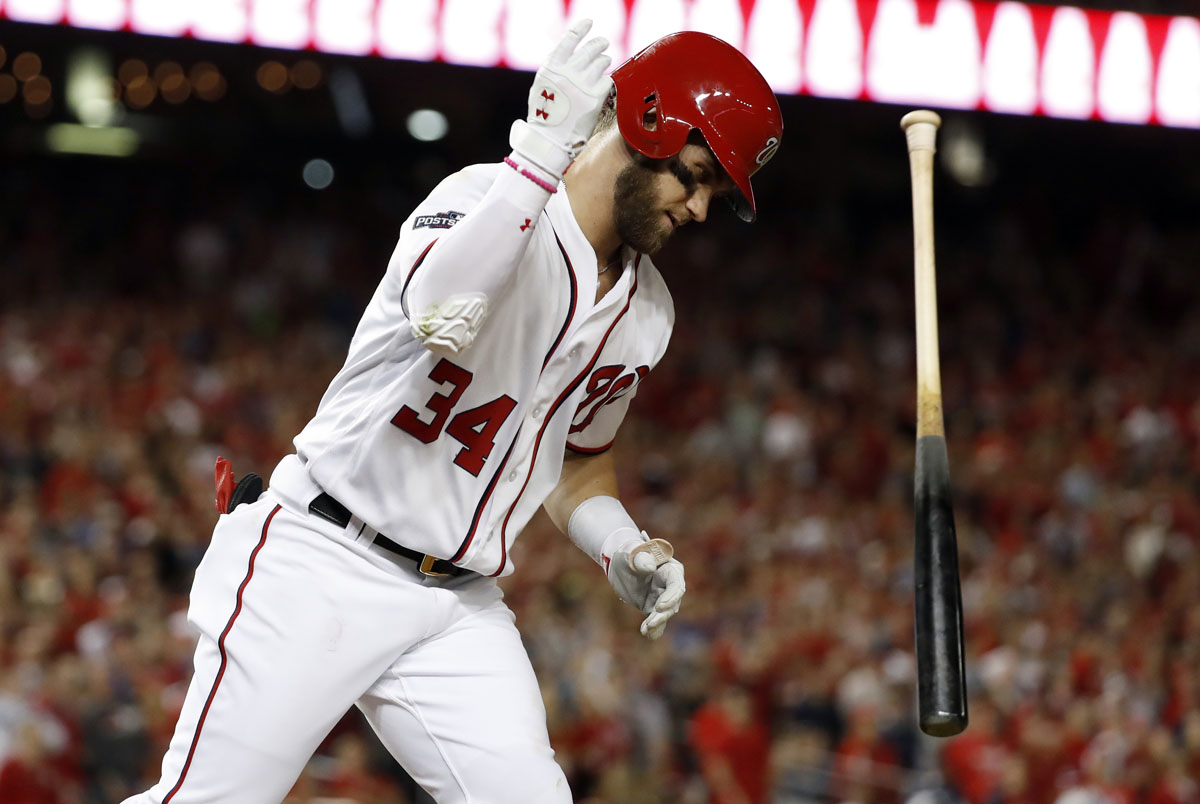 Washington Nationals' Bryce Harper flips his bat after hitting an infield pop fly during the fourth inning of Game 1 of a baseball National League Division Series against the Los Angeles Dodgers, at Nationals Park, Friday, Oct. 7, 2016, in Washington. (AP Photo/Alex Brandon)