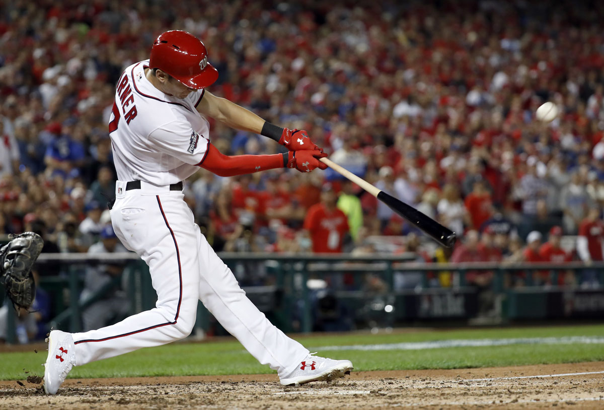 Washington Nationals' Trea Turner hits an RBI sacrifice fly against the Los Angeles Dodgers during the the fourth inning of Game 1 of a baseball National League Division Series, at Nationals Park, Friday, Oct. 7, 2016, in Washington. (AP Photo/Alex Brandon)
