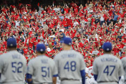 Members of the Los Angeles Dodgers look on as fans cheer as the Washington Nationals starting lineup is announced during festivities before Game 1 of baseball's National League Division Series at Nationals Park, Friday, Oct. 7, 2016, in Washington. (AP Photo/Pablo Martinez Monsivais)