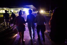 Displaced residents from Hurricane Matthew walk into a shelter in Bluffton, S.C., Sunday, Oct. 9, 2016. Gov. Nikki Haley lifted evacuation orders in Beaufort and Jasper Counties at 6:30 p.m., but most residents will have to wait until Monday morning to return to their homes because Beaufort County has a 7 p.m. curfew in place. (AP Photo/David Goldman)