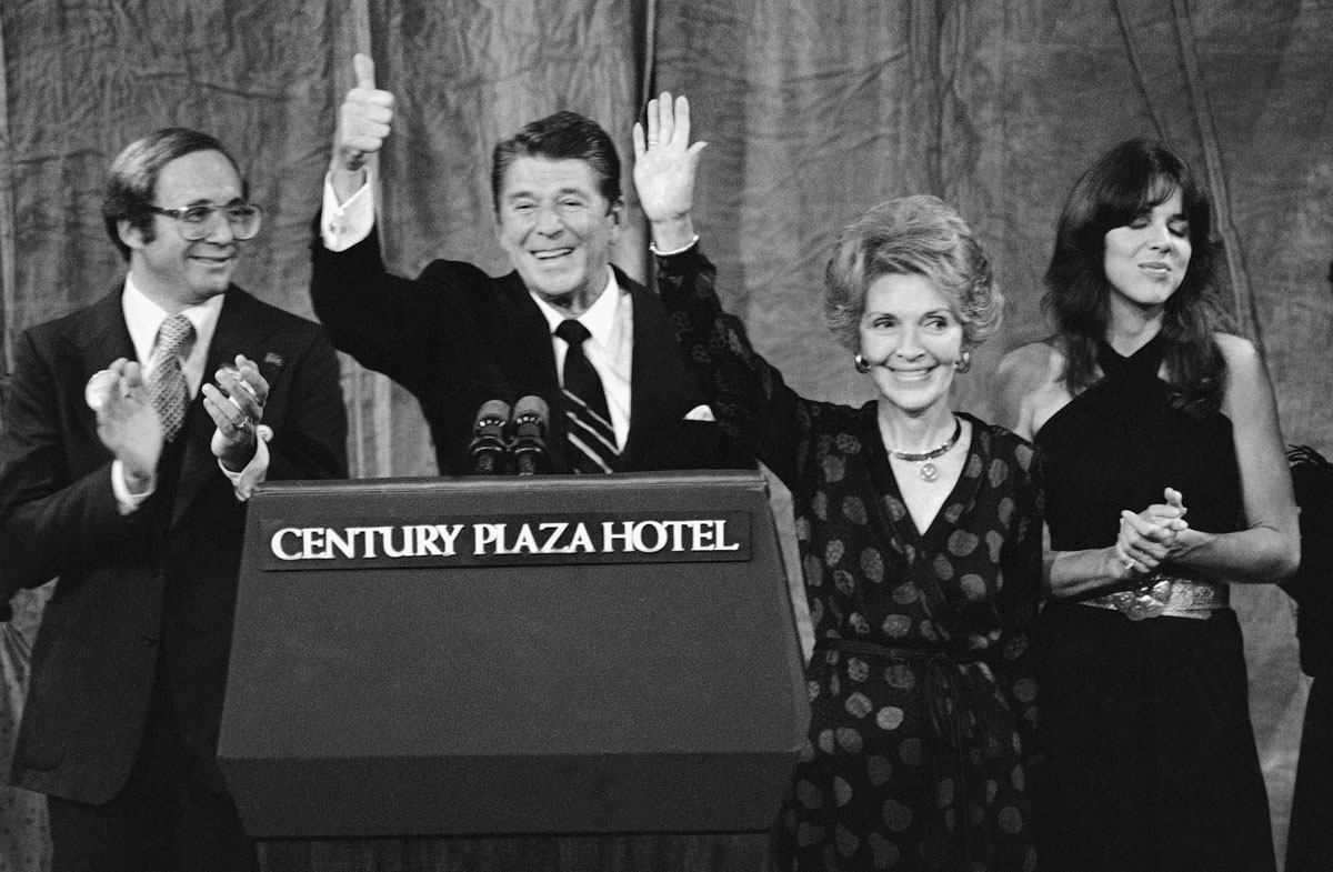 President-elect Ronald Reagan and his wife Nancy wave to supporters after speaking at his election night headquarters in Los Angeles at night on Tuesday, Nov. 5, 1980. Reagan swept to an unusually lopsided win over President Jimmy Carter. (AP Photo)