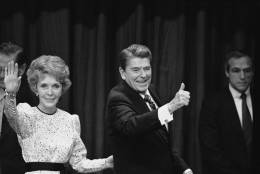 Nancy and Ronald Reagan signal to well-wishers and supporters at the Century Plaza Hotel at night, Tuesday, Nov. 7, 1984 in Los Angeles after Reagan was declared the winner in the 1984 presidential election against Democratic opponent Walter Mondale. (AP Photo)
