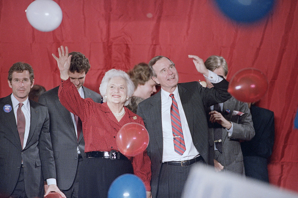 Vice President George H. Bush and Barbara Bush wave as balloons are dropped during a welcome rally in Houston, Nov. 8, 1988.  Bush will watch the election results in Houston on Tuesday. (AP Photo/John Duricka)
