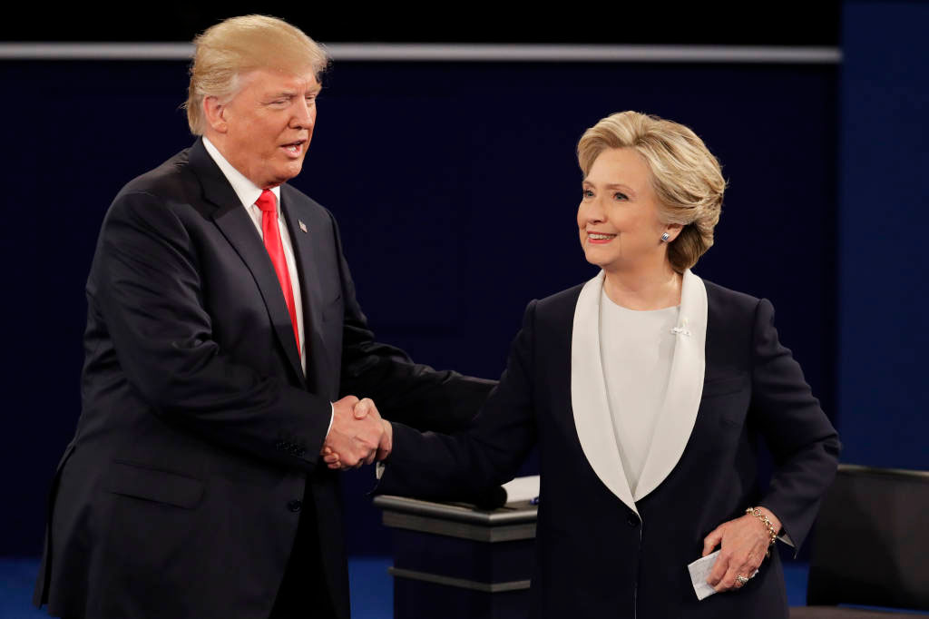 Republican presidential nominee Donald Trump and Democratic presidential nominee Hillary Clinton shake hands after the second presidential debate at Washington University in St. Louis, Sunday, Oct. 9, 2016. (AP Photo/Julio Cortez)