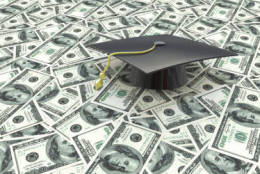 Mini graduation cap on US money -- education costs