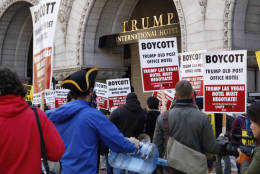 Protesters outside the Trump International Hotel Oct. 26, protesting the hotel's official opening. (WTOP/Kate Ryan)