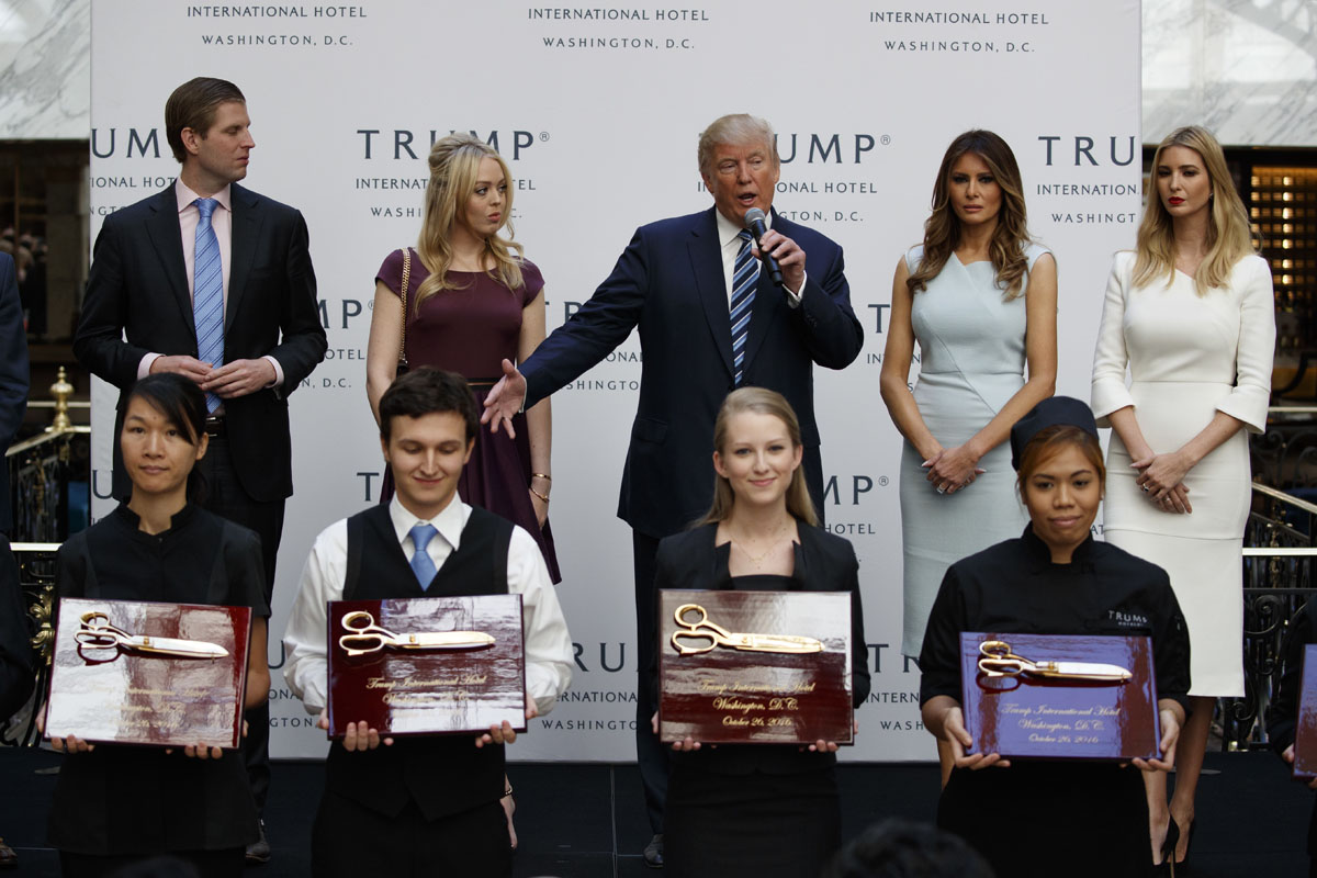 Republican presidential candidate Donald Trump, accompanied by, from left, Donald Trump Jr., Tiffany Trump, Melanie Trump and Ivanka Trump,  speaks during the grand opening of the Trump International Hotel- Old Post Office, Wednesday, Oct. 26, 2016, in Washington. (AP Photo/ Evan Vucci)