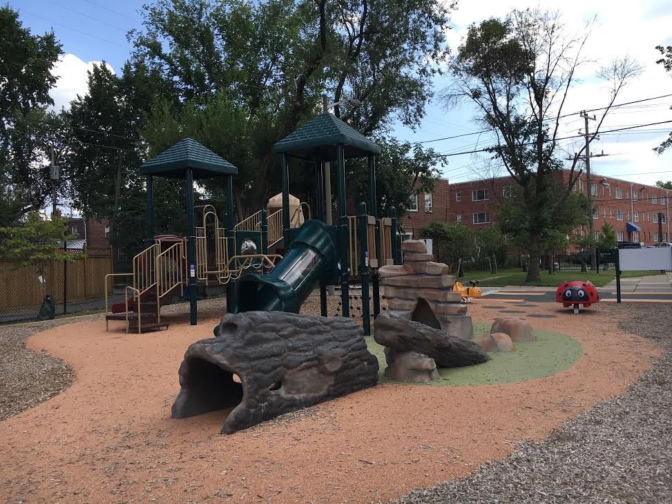 The Hume Springs Park playground in the Arlandria area of Alexandria, Va., underwent renovations in September 2015, as seen in this photo. The nonprofit organization RunningBrooke transformed the space into a family-friendly environment by updating the equipment, adding gardens with native trees and plants, and installing benches and water fountains. (WTOP/Jamie Forzato)