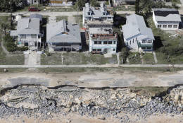 In this aerial photo, portions of SR A1A are washed out from Hurricane Matthew, Saturday, Oct. 8, 2016, in Flagler Beach, Fla.  The damage from Matthew caused  beach erosion, washed out some roads and knocked out power for more than 1 million customers in several coastal counties. (AP Photo/Chris O'Meara)