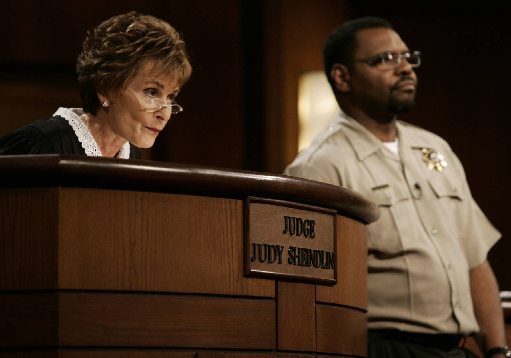 Judge Judy Sheindlin presides over a case as her bailiff Petri Hawkins Byrd listens on the set of her syndicated show "Judge Judy," Thursday, Feb. 2, 2006, at the Tribune Studios in Los Angeles. (AP Photo/Damian Dovarganes)