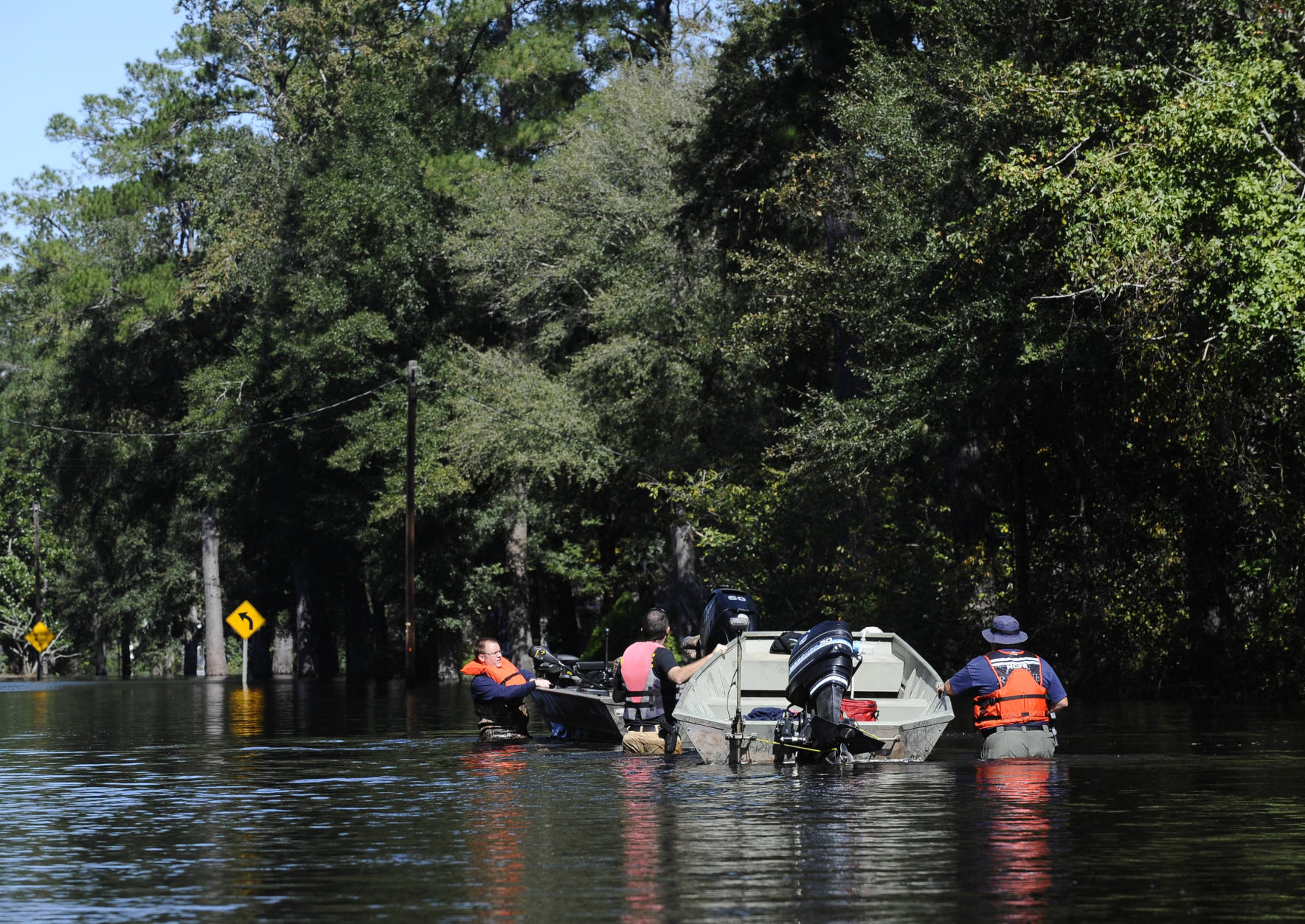 People use a boat to navigate floodwaters on Highway 9, Tuesday, Oct. 11, 2016, in Nichols, S.C. About 150 people were rescued by boats from flooding in the riverside village of Nichols on Monday. (AP Photo/Rainier Ehrhardt)