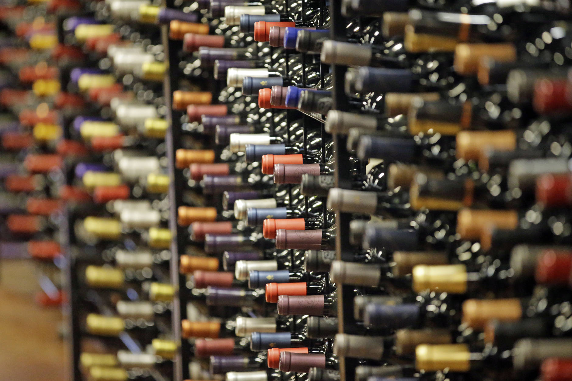 FILE - In this June 16, 2016, file photo, bottles of wine are displayed during a tour of a state liquor store, in Salt Lake City. Cheap liquor, wine and beer have long been best-sellers among Utah alcohol drinkers, but new numbers from Utah's tightly-controlled liquor system show local craft brews, trendy box wines and flavored whiskies are also popular choices in a largely teetotaler state. (AP Photo/Rick Bowmer, File)