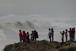 People stand on the coast watching the surf produced by Hurricane Matthew, on the outskirts of Kingston, Jamaica, Monday, Oct. 3, 2016. A hurricane warning is in effect for Jamaica, Haiti, and the Cuban provinces of Guantanamo, Santiago de Cuba, Holguin, Granma and Las Tunas - as well as the southeastern Bahamas. (AP Photo/Eduardo Verdugo)