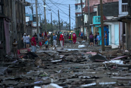 Red Cross workers and residents walk among the damage caused by Hurricane Matthew in Baracoa, Cuba, Wednesday, Oct. 5, 2016. The hurricane rolled across the sparsely populated tip of Cuba overnight, destroying dozens of homes in Cuba's easternmost city, Baracoa, and leaving hundreds of others damaged.(AP Photo/Ramon Espinosa)