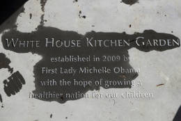 A new paver etched with markings "White House Kitchen Garden" is seen at the entrance to the White House Kitchen Garden at the White House in Washington, Wednesday, Oct. 5, 2016. Michelle Obama is going all-out to ensure the White House kitchen garden that she created in 2009 doesn't get plowed under by the next first family. A month out from Election Day, the first lady’s office unveiled an expanded and improved garden, with the hope that it will endure regardless of who takes office come January.  (AP Photo/Manuel Balce Ceneta)