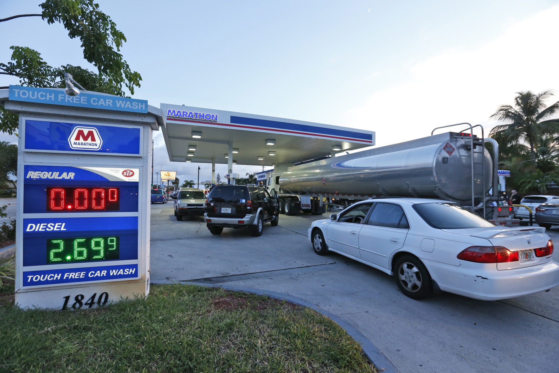 Drivers wait as a truck fills the empty tanks of a Marathon gasoline station, Wednesday, Oct. 5, 2016, in Hollywood, Fla. Hurricane Matthew marched toward Florida, Georgia and the Carolinas and nearly 2 million people along the coast were urged to evacuate their homes Wednesday, a mass exodus ahead of a major storm packing power the U.S. hasn't seen in more than a decade. (AP Photo/Wilfredo Lee)