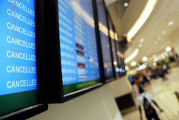 A departure board displays flight cancellations to Miami at Hartsfield-Jackson Atlanta International Airport in Atlanta, Thursday, Oct. 6, 2016. Airlines canceled hundreds of flights for Thursday and again Friday as Hurricane Matthew pelted the Florida coast with high winds and heavy rain. (AP Photo/David Goldman)