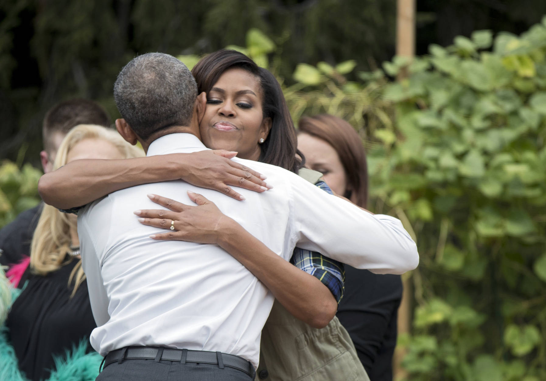 President Barack Obama hugs first lady Michelle Obama, during a surprise visit at the harvest of the White House Kitchen Garden on the South Lawn in Washington, Thursday, Oct. 6, 2016.   (AP Photo/Manuel Balce Ceneta)