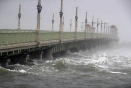Waves from Hurricane Matthew crash against a bridge Friday, Oct. 7, 2016, in St. Augustine, Fla.  Matthew was downgraded to a Category 3 hurricane overnight, and its storm center hung just offshore as it moved up the Florida coastline, sparing communities its full 120 mph winds.  (AP Photo/John Bazemore)