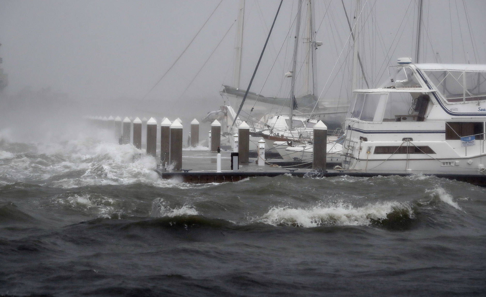 Waves from Hurricane Matthew batter a boat dock Friday, Oct. 7, 2016, in St. Augustine , Fla.  Matthew was downgraded to a Category 3 hurricane overnight, and its storm center hung just offshore as it moved up the Florida coastline, sparing communities its full 120 mph winds.  (AP Photo/John Bazemore)