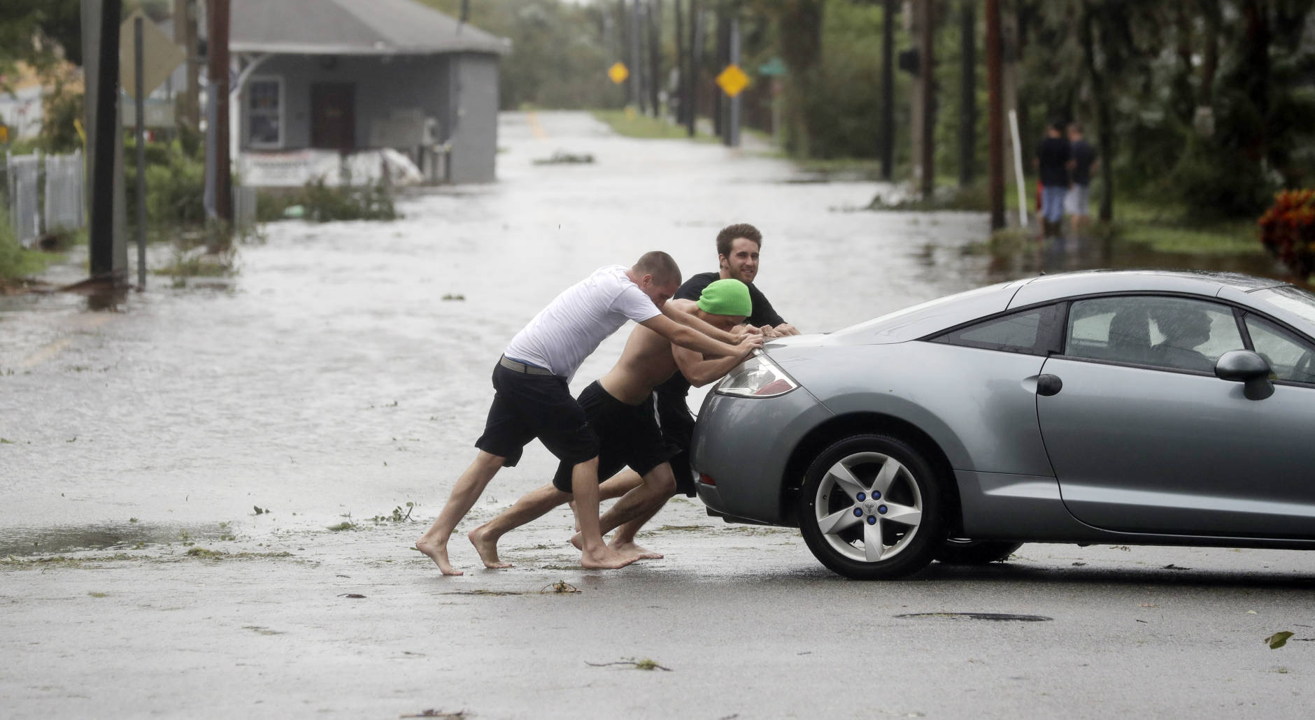 Noah Simons steers as his car is pushed out of flood waters caused by Hurricane Matthew, Friday, Oct. 7, 2016, in Daytona Beach, Fla. Hurricane Matthew spared Florida’s most heavily populated stretch from a catastrophic blow Friday but threatened some of the South’s most historic and picturesque cities with ruinous flooding and wind damage as it pushed its way up the coastline.  (AP Photo/Eric Gay)