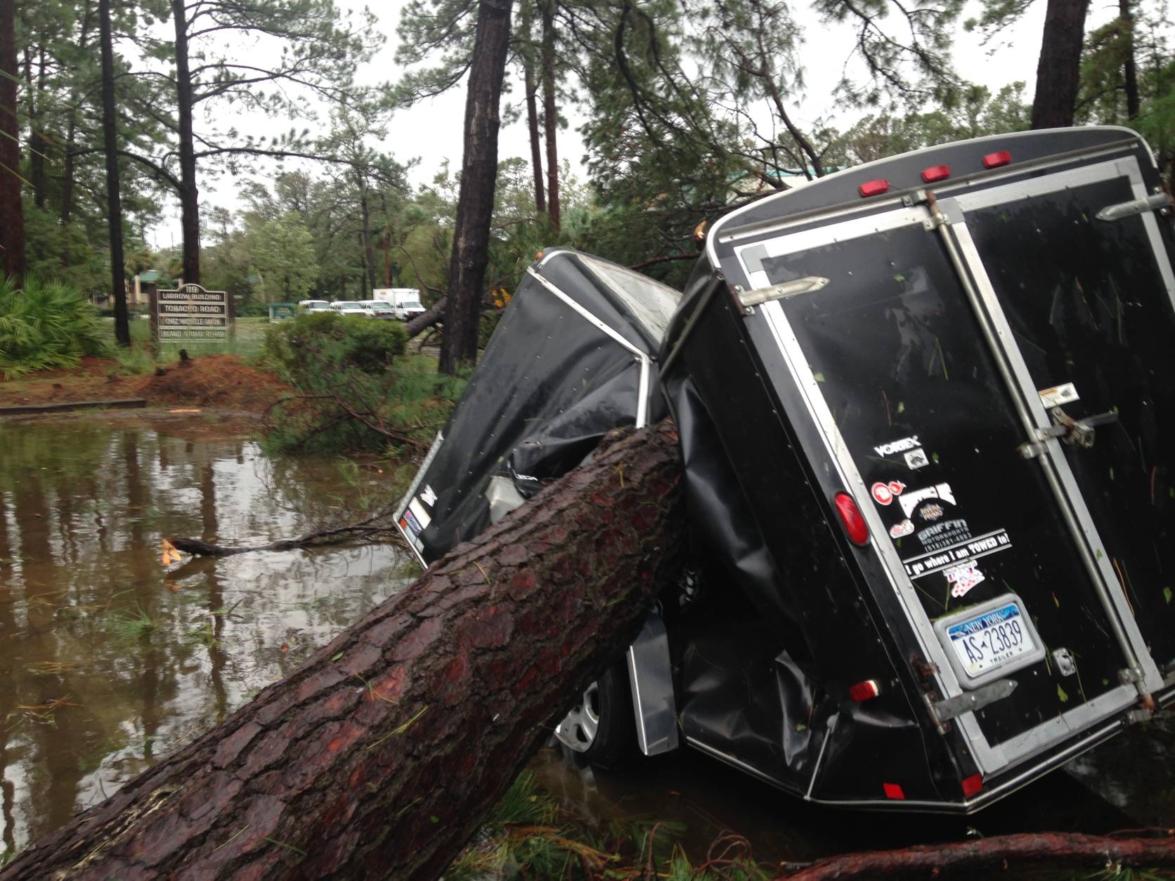 A trailer is destroyed from a fallen tree  in the aftermath of Hurricane Matthew at Hilton Head, S.C., on Saturday, Oct. 8, 2016.  Matthew plowed north along the Atlantic coast, flooding towns and gouging out roads in its path.   (AP Photo/Jeffrey Collins)