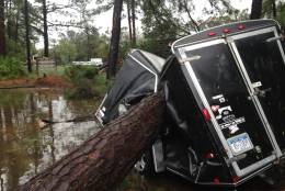 A trailer is destroyed from a fallen tree  in the aftermath of Hurricane Matthew at Hilton Head, S.C., on Saturday, Oct. 8, 2016.  Matthew plowed north along the Atlantic coast, flooding towns and gouging out roads in its path.   (AP Photo/Jeffrey Collins)