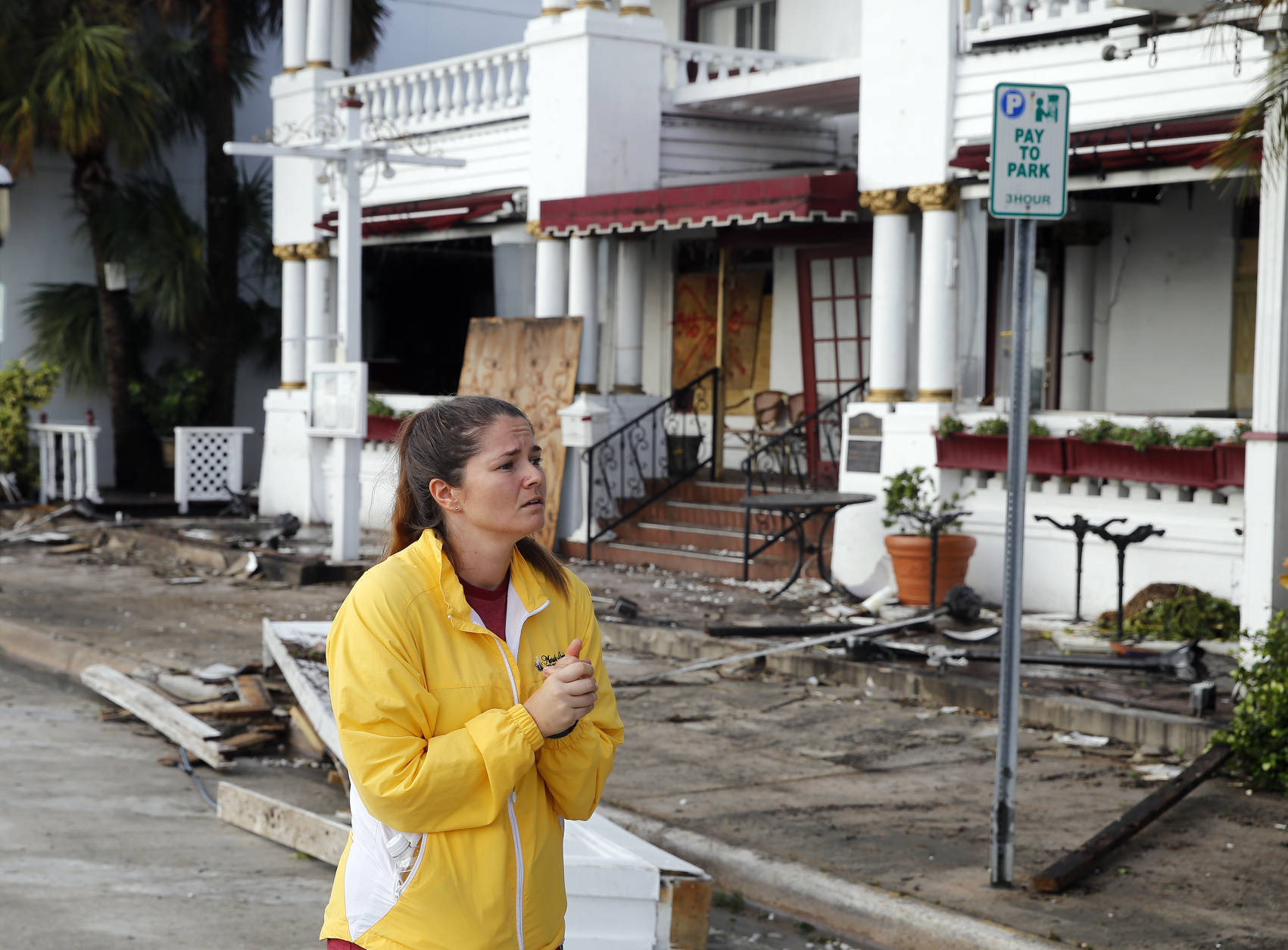 Sammantha Weber looks over storm damage from Hurricane Matthew at the Casablanco Inn Saturday, Oct. 8, 2016, in St. Augustine , Fla.  Matthew plowed north along the Atlantic coast, flooding towns and gouging out roads in its path. (AP Photo/John Bazemore)