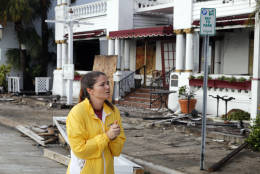 Sammantha Weber looks over storm damage from Hurricane Matthew at the Casablanco Inn Saturday, Oct. 8, 2016, in St. Augustine , Fla.  Matthew plowed north along the Atlantic coast, flooding towns and gouging out roads in its path. (AP Photo/John Bazemore)