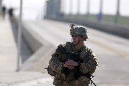 A soldier keeps traffic off a closed bridge a day after Hurricane Matthew moved up the coast Saturday, Oct. 8, 2016, in St. Augustine, Fla. Matthew spared Florida's most heavily populated stretch from a catastrophic blow Friday but threatened some of the South's most historic and picturesque cities with ruinous flooding and wind damage as it pushed its way up the coastline.  (AP Photo/John Bazemore)