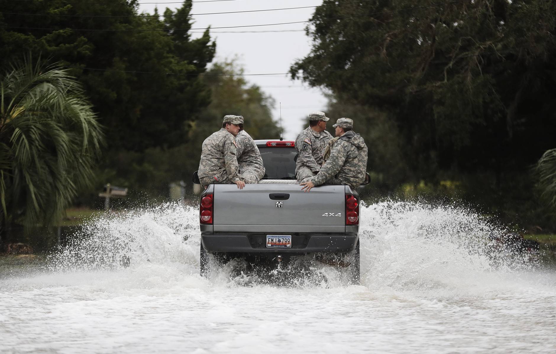 Members of the National Guard patrol through a flooded street after Hurricane Matthew hit the tiny beach community of Edisto Beach, S.C., Saturday, Oct. 8, 2016. (AP Photo/David Goldman)